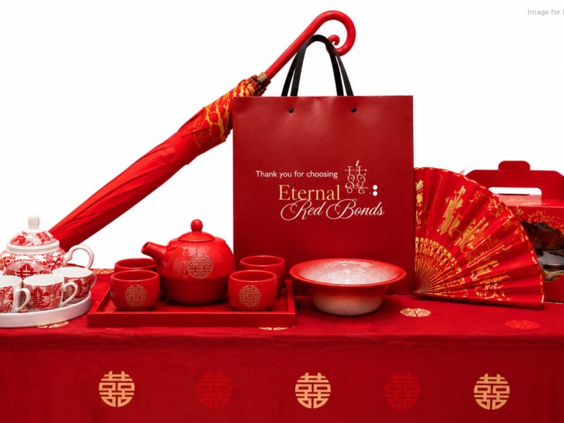 Simplified Dowry Package 新娘嫁妆 items: tea sets, bowl, umbrella, fan and gift box on a red double happiness tablecloth